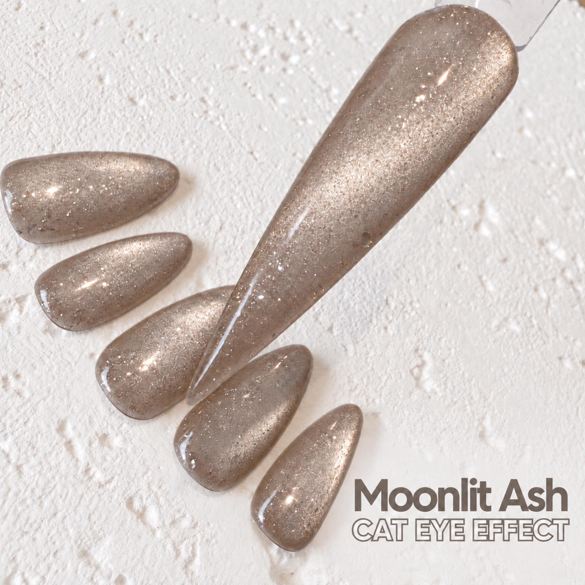 a close-up view of a nail polish bottle with a metallic silver glittery nail polish applied to it.