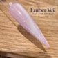 A close-up image of a glittery nail polish bottle on a wooden surface, with the text "Ember Veil CAT EYE EFFECT" displayed above it.