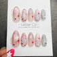 A set of colorful and decorated nail art designs featuring stars and glitter, presented on a white background.