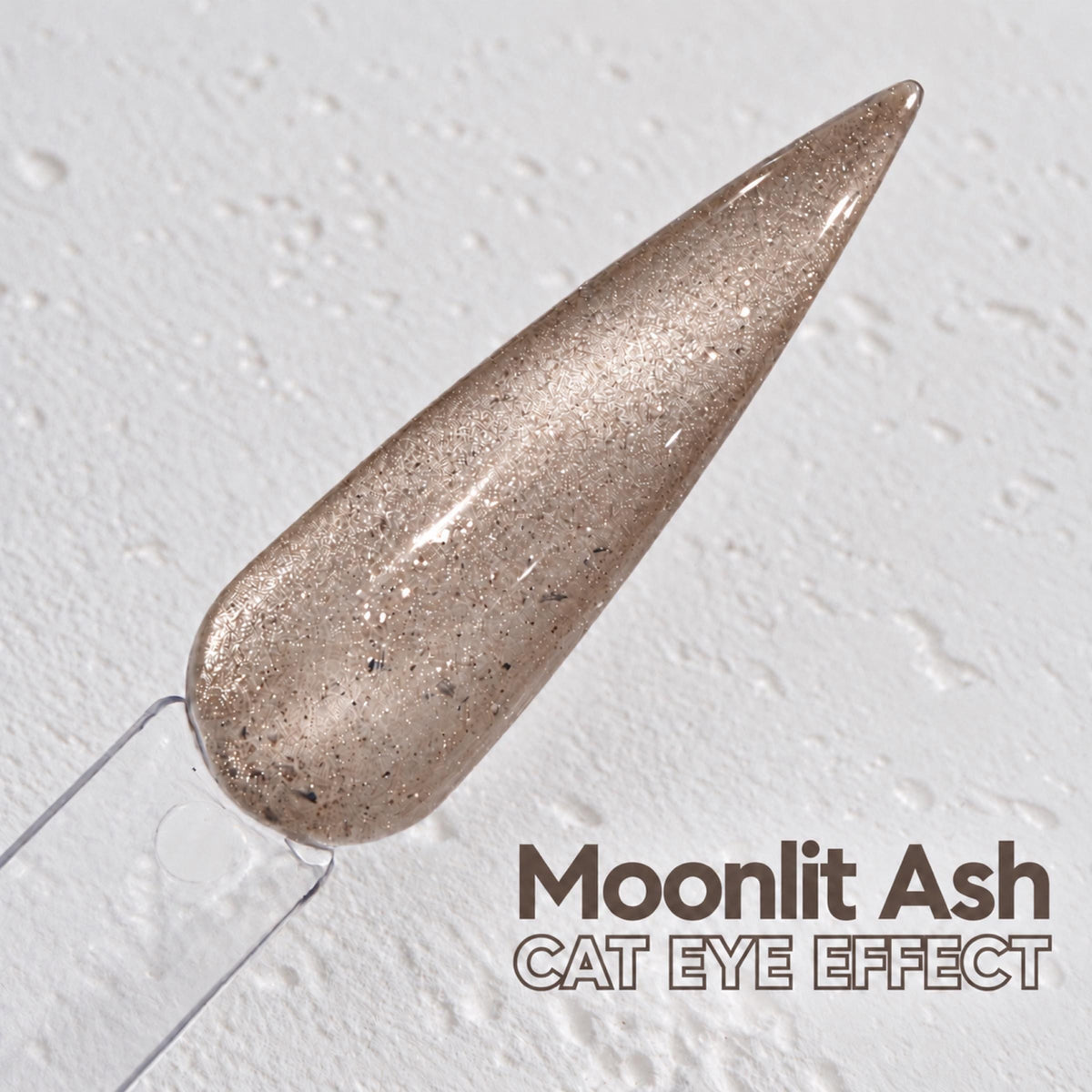 A close-up image of a nail polish swatch with a text overlay that reads "Moonlit Ash CAT EYE EFFECT".