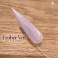 A close-up image of a glittery nail polish bottle on a wooden surface, with the text "Ember Veil CAT EYE EFFECT" displayed below it.