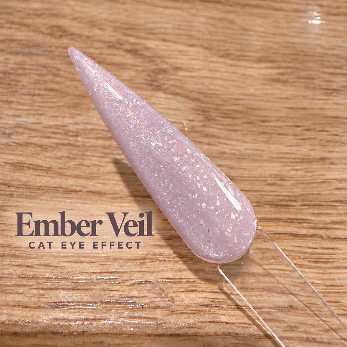 A close-up image of a glittery nail polish bottle on a wooden surface, with the text "Ember Veil CAT EYE EFFECT" displayed below it.